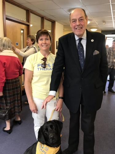 Sir Nicholas at the official opening of Age UK East Grinstead and District with Millie the therapy dog.